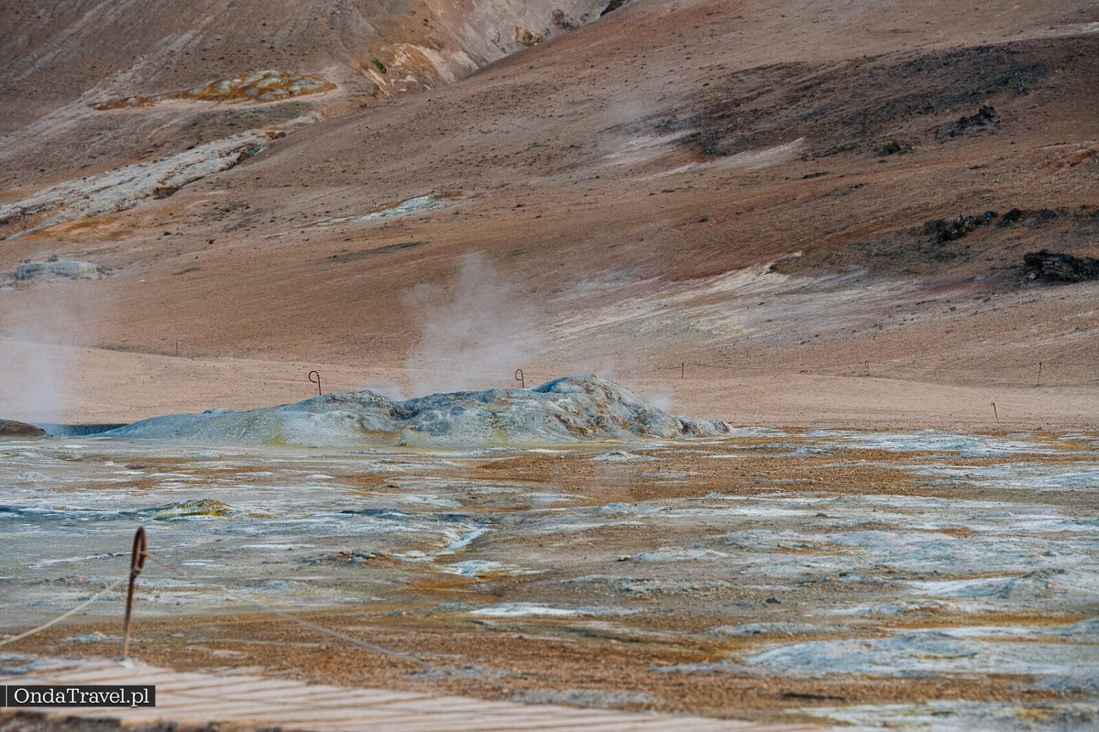 Aberturas geotérmicas humeantes con la ladera de Námafjall al fondo
