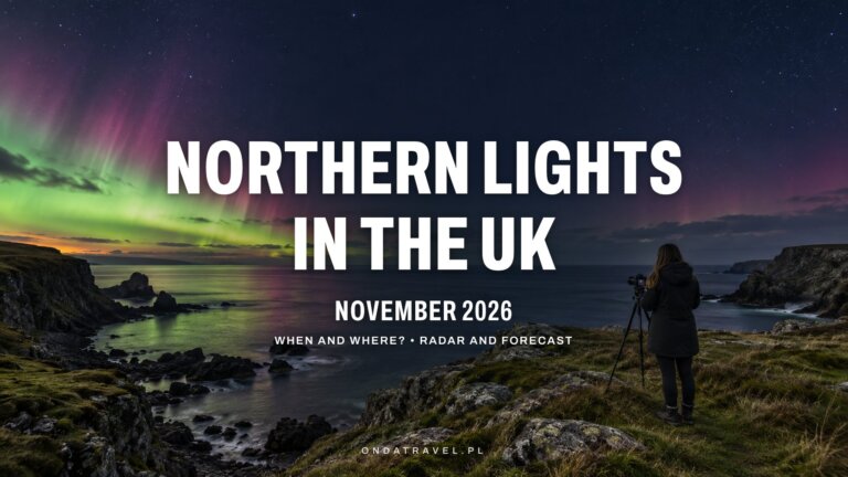 Green and pink aurora over a rocky UK coastline at night, woman with a camera on a tripod