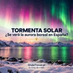 Aurora boreal sobre un fiordo nevado de Noruega durante la tormenta geomagnética de octubre de 2026, una mujer fotografía la aurora con el móvil